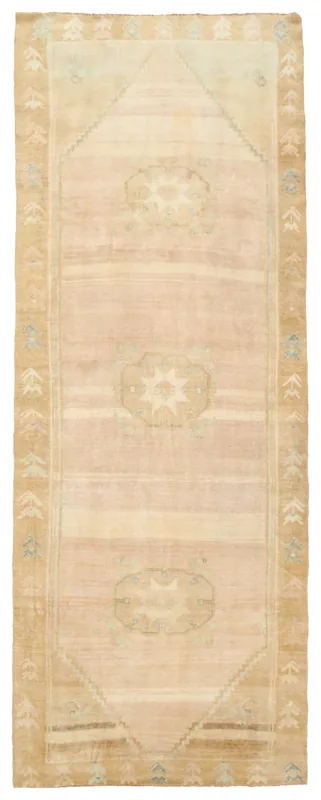Full overhead view of the 4'7" x 12'5" vintage Anatolian runner with faded rose field and tan border