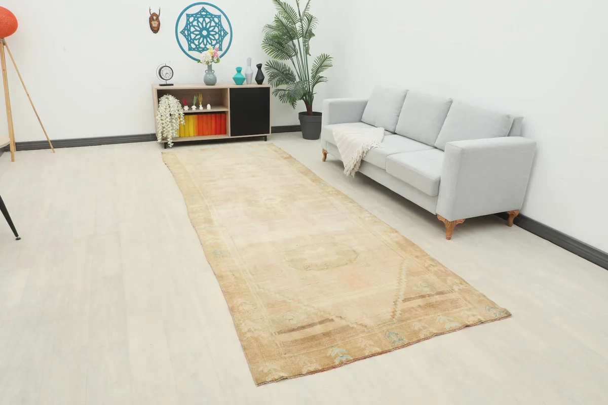 Vintage runner rug in a modern living space with light walls and a gray sofa