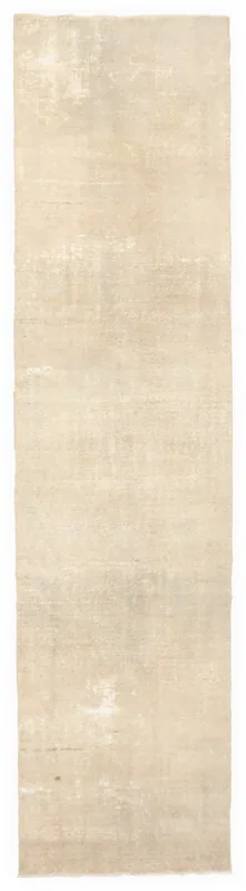 Full overhead view of the beige distressed geometric runner rug on a white background