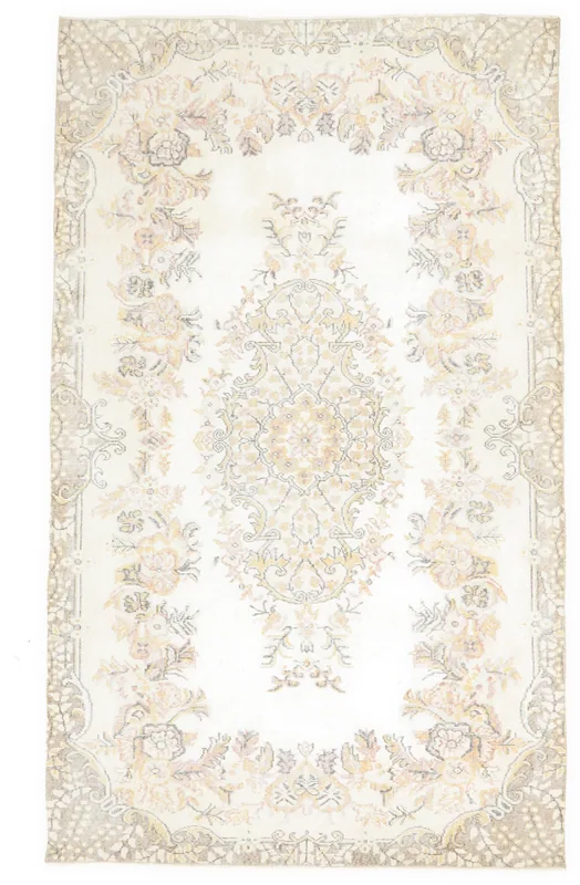 Full top view of the 5'5" x 9'0" ivory vintage Anatolian rug on a white background, showcasing its floral medallion