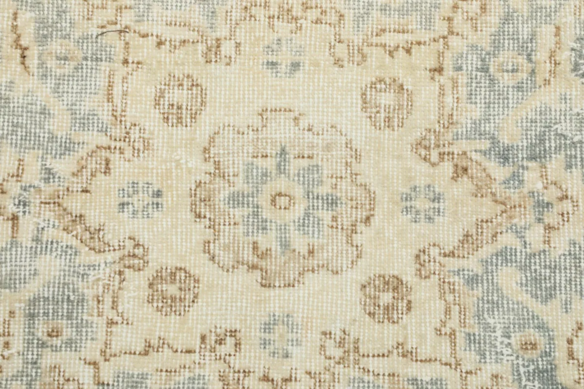 Detailed view of the floral motifs and subtle color variations in the rug's pile