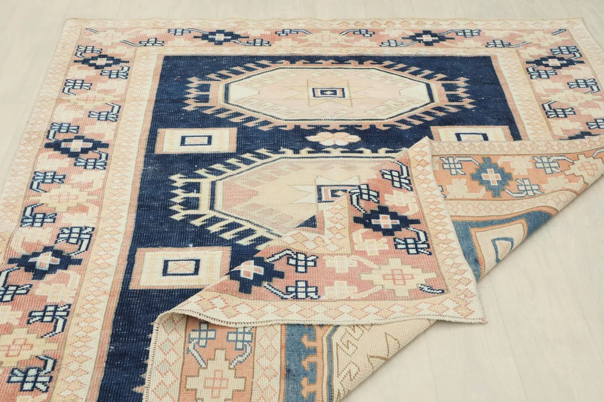 Rug partially folded, highlighting the craftsmanship and wool pile.