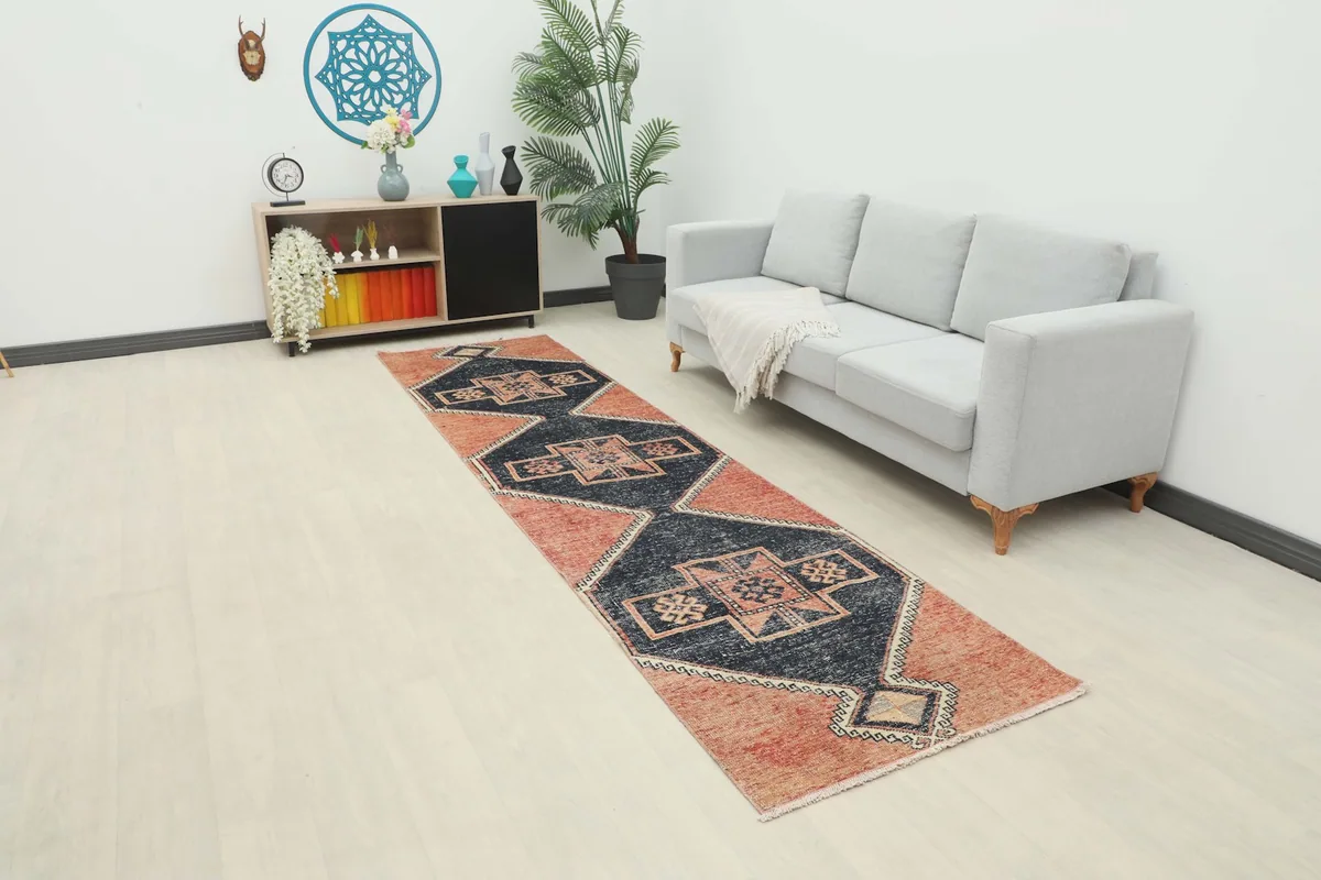 Anatolian runner rug with rust and navy colors placed in a modern living space hallway