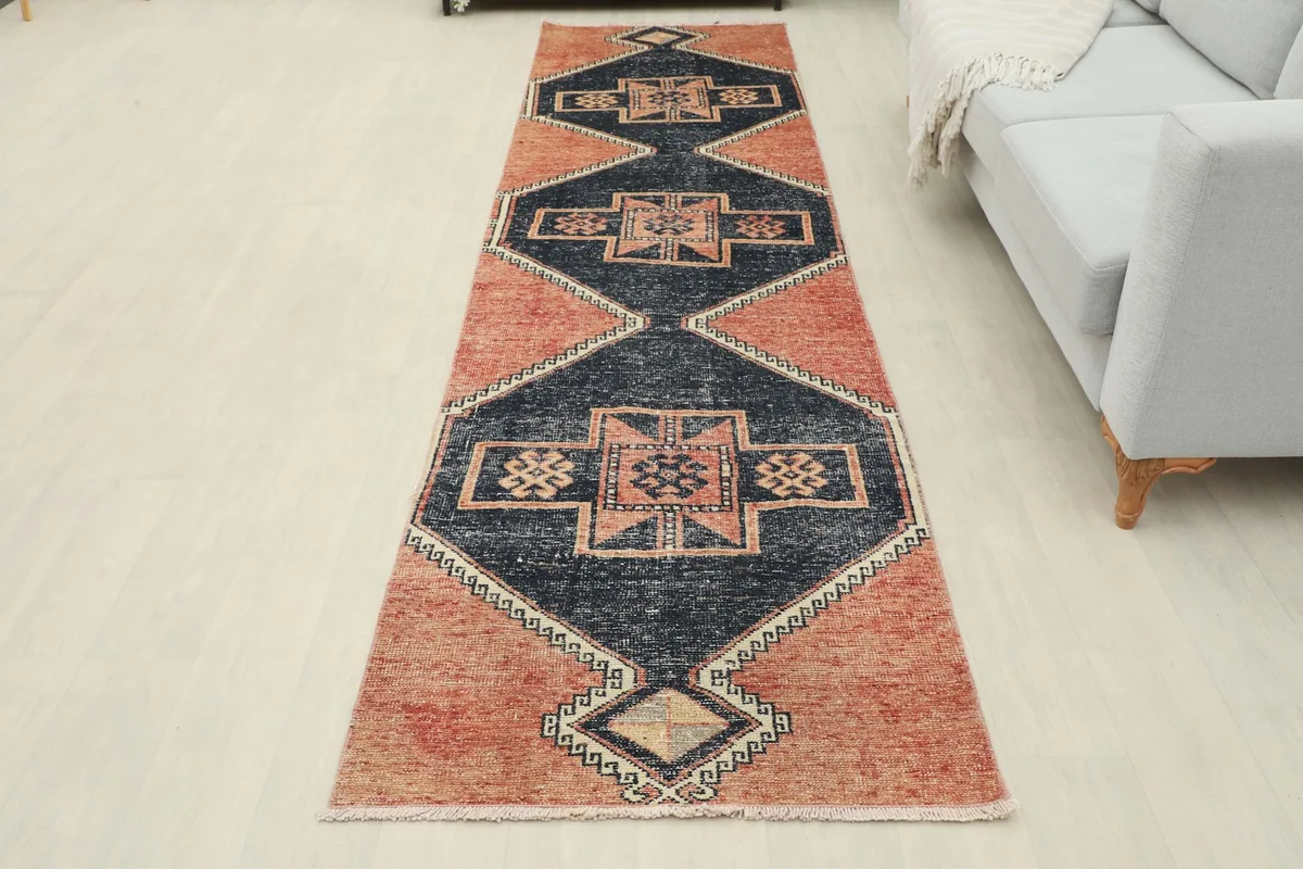 Full overhead view of the rust and navy vintage runner rug in a room setting