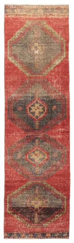 Full overhead view of the red geometric Anatolian runner on a white background