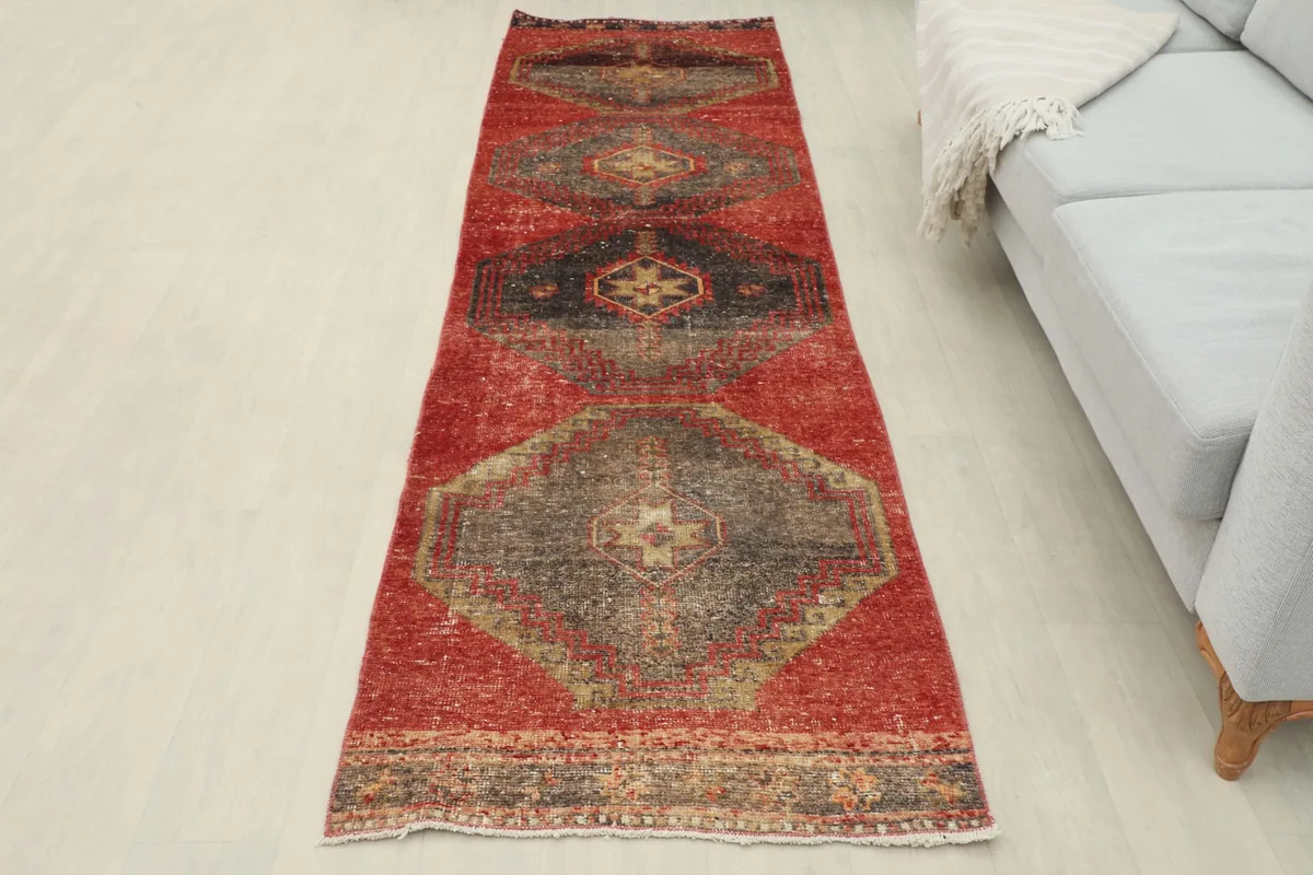 Full room view of the red runner, providing a sense of its size and placement in a home