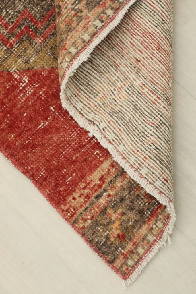 View of the underside of the hand-knotted wool runner, showing the cotton foundation