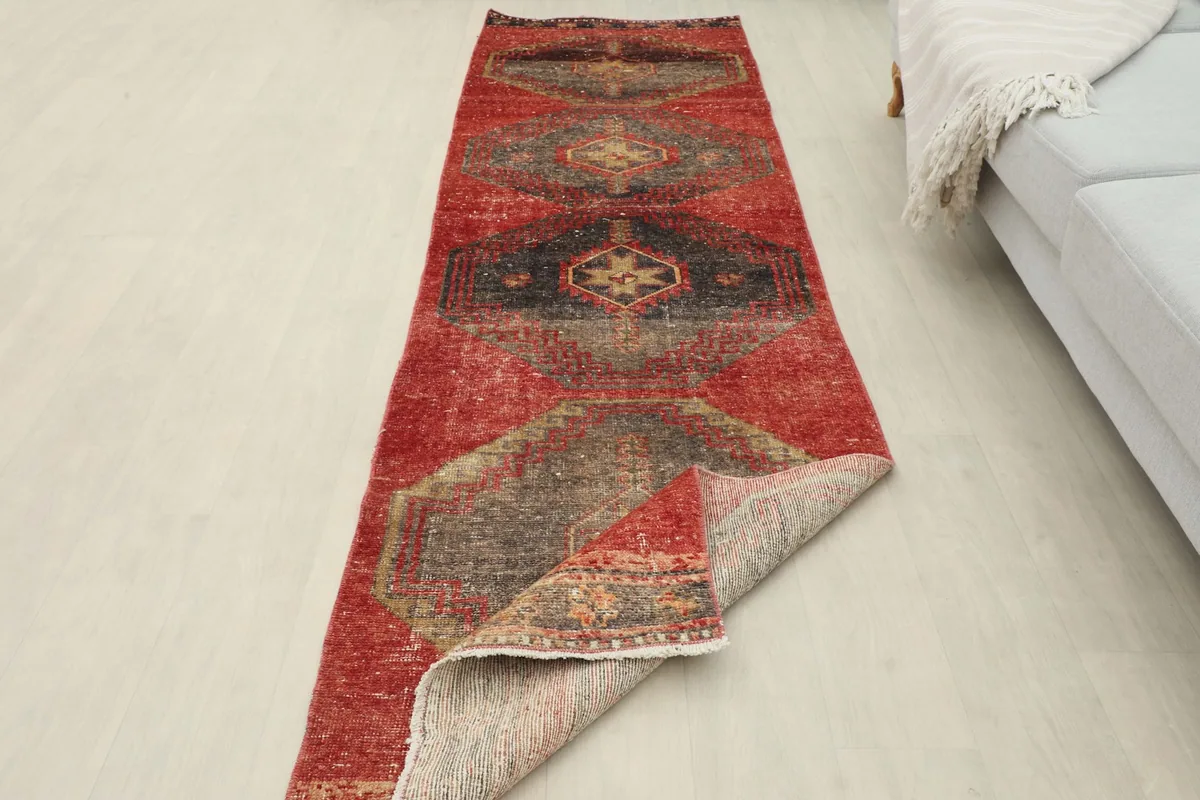 Runner partially folded to show the thickness and flexibility of the vintage wool rug