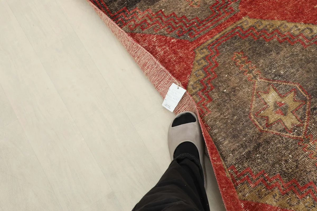 Foot next to the runner, indicating scale and the low pile texture