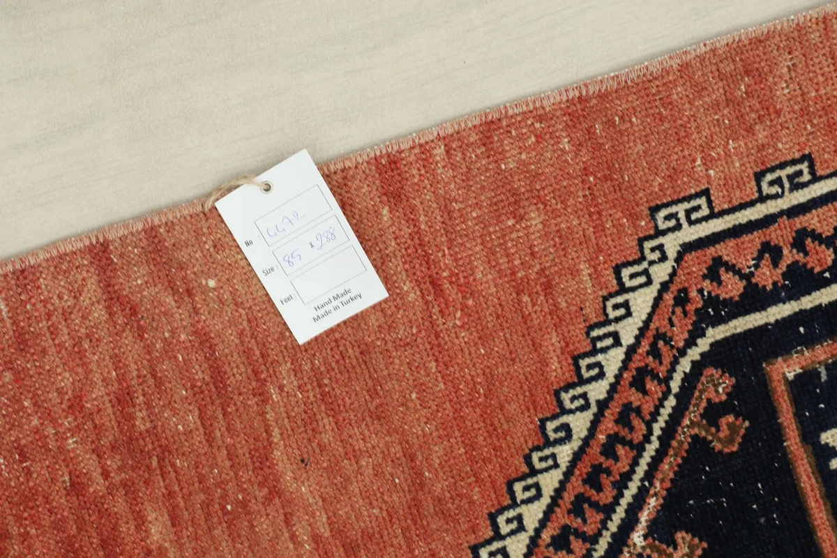 Corner of the rug with the product tag, showing details of its origin and material