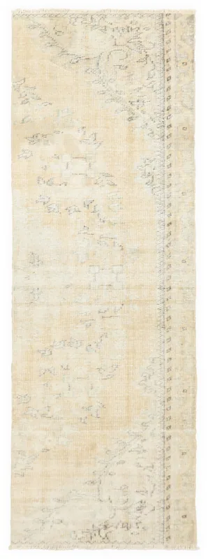 Full overhead view of the beige faded floral runner on a white background