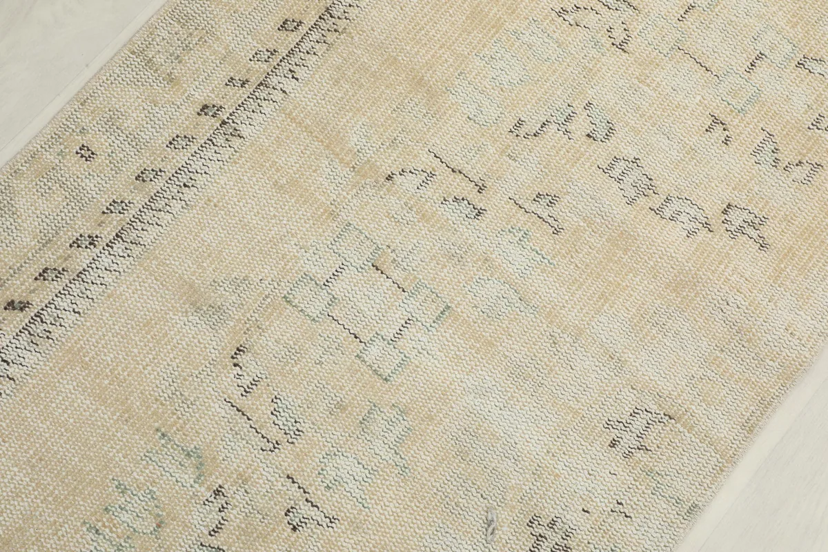Detailed view of the central section of the runner, showing subtle geometric and floral designs