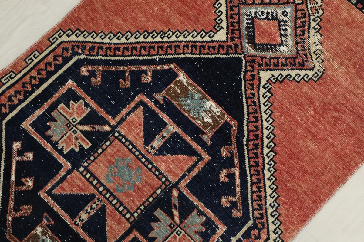 Detailed shot of the rug's corner, showing the intricate geometric border and medallion edge