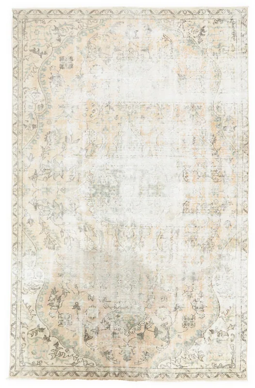 Full overhead view of the 5'5" x 8'7" vintage Anatolian rug on a white background, showing its faded ivory and beige colors.