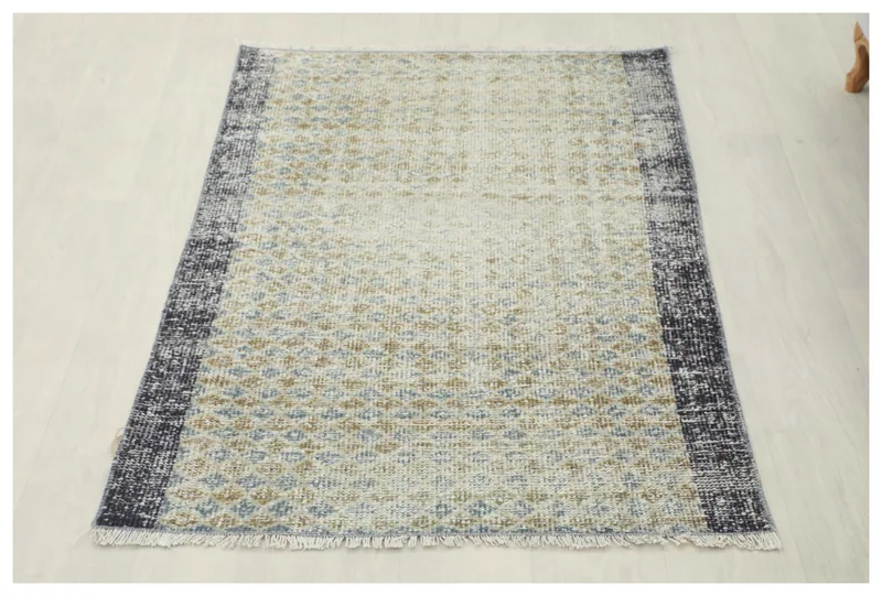 Full top view of the 2'10" x 4'1" ivory, blue, and tan geometric vintage Anatolian rug on a white background.