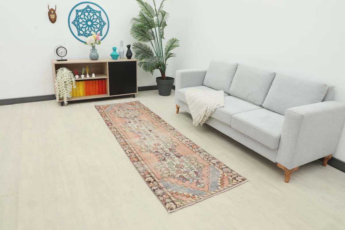 Vintage Anatolian runner rug in a modern living space with a grey couch