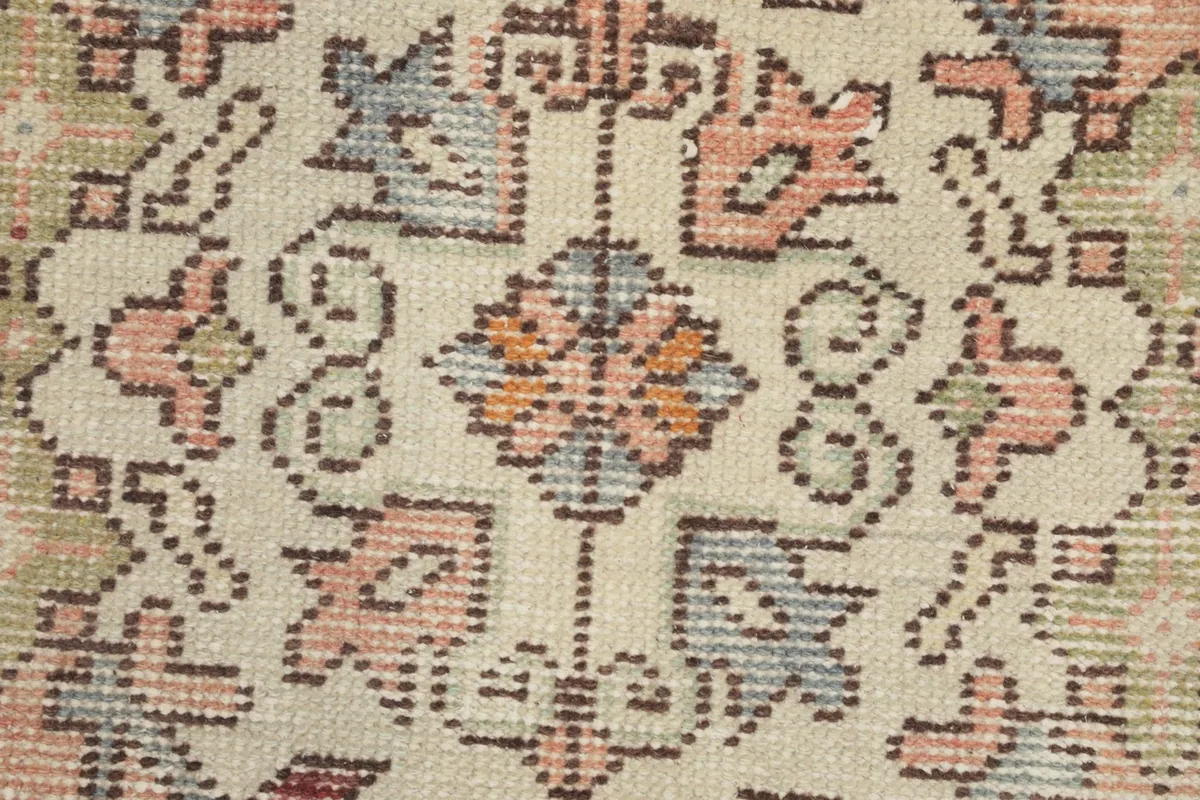 Close-up of the hand-knotted wool pile, showing texture and color variations