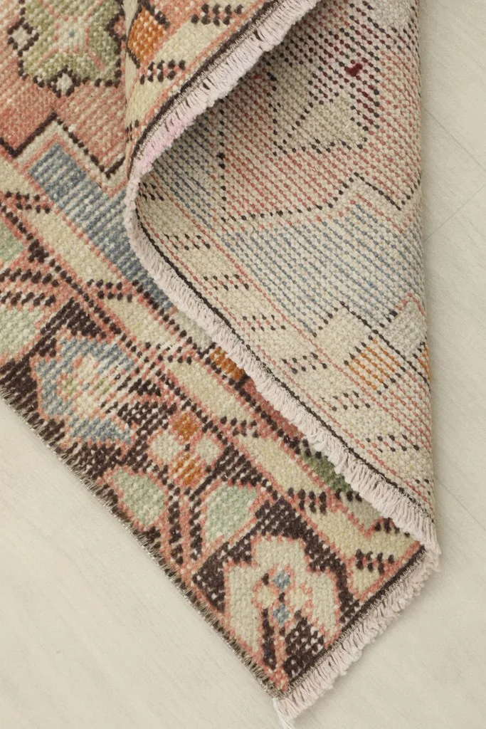 View of the back of the rug, showing the cotton foundation and knotting