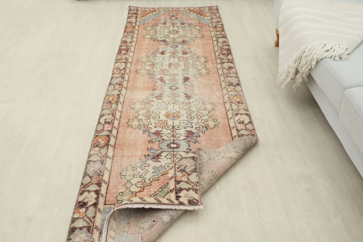 Runner rug partially folded to show its flexibility and thickness