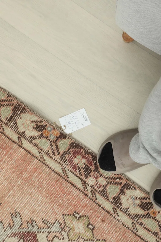 Overhead view showing the rug's label and a foot for scale