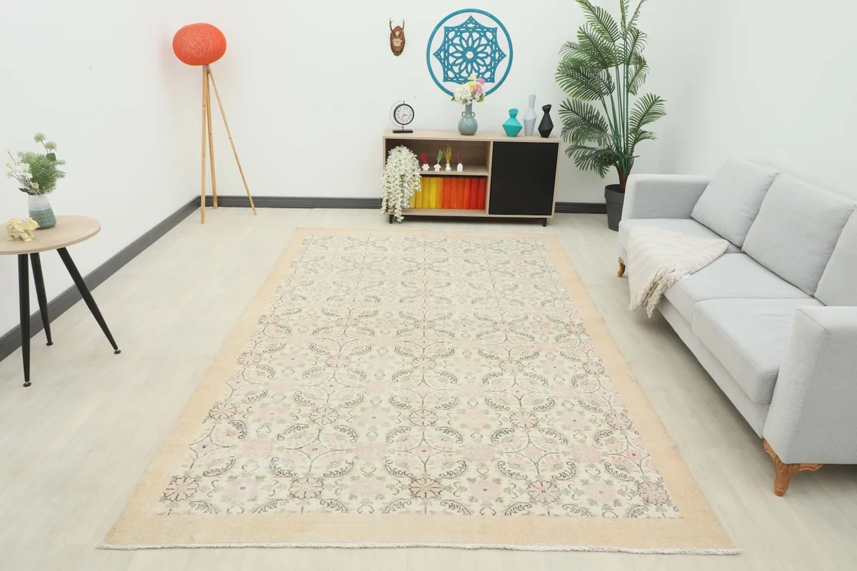 Full room view with the rug as a central element, showcasing its light colors and patterns in a bright space.