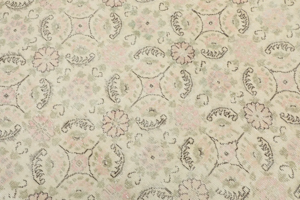 Detailed close-up of the rug's pattern, revealing the hand-knotted texture and intricate floral lattice motifs.