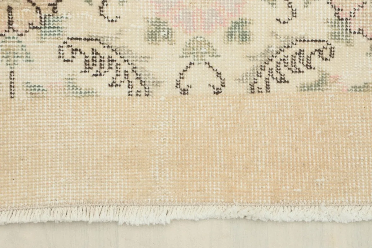View of the back of the rug and the fringe, demonstrating the cotton foundation and hand-knotted construction.