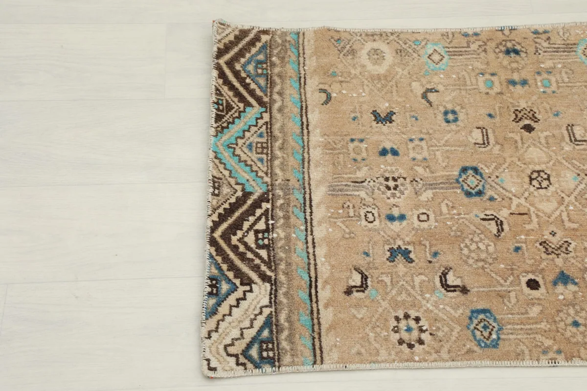 Close-up of the opposite short end border with intricate blue and brown tribal designs