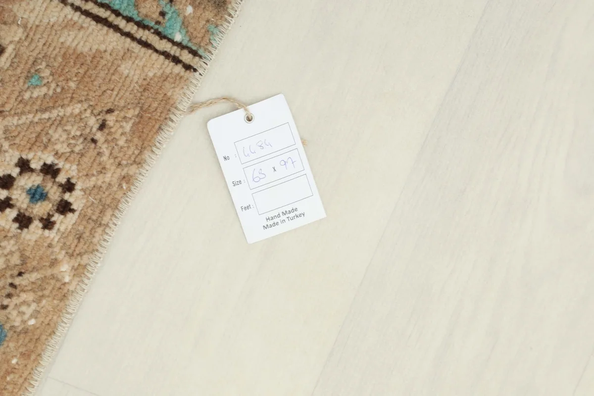 Product tag showing the dimensions 63 x 97 cm and 'Hand Made in Turkey' next to the rug