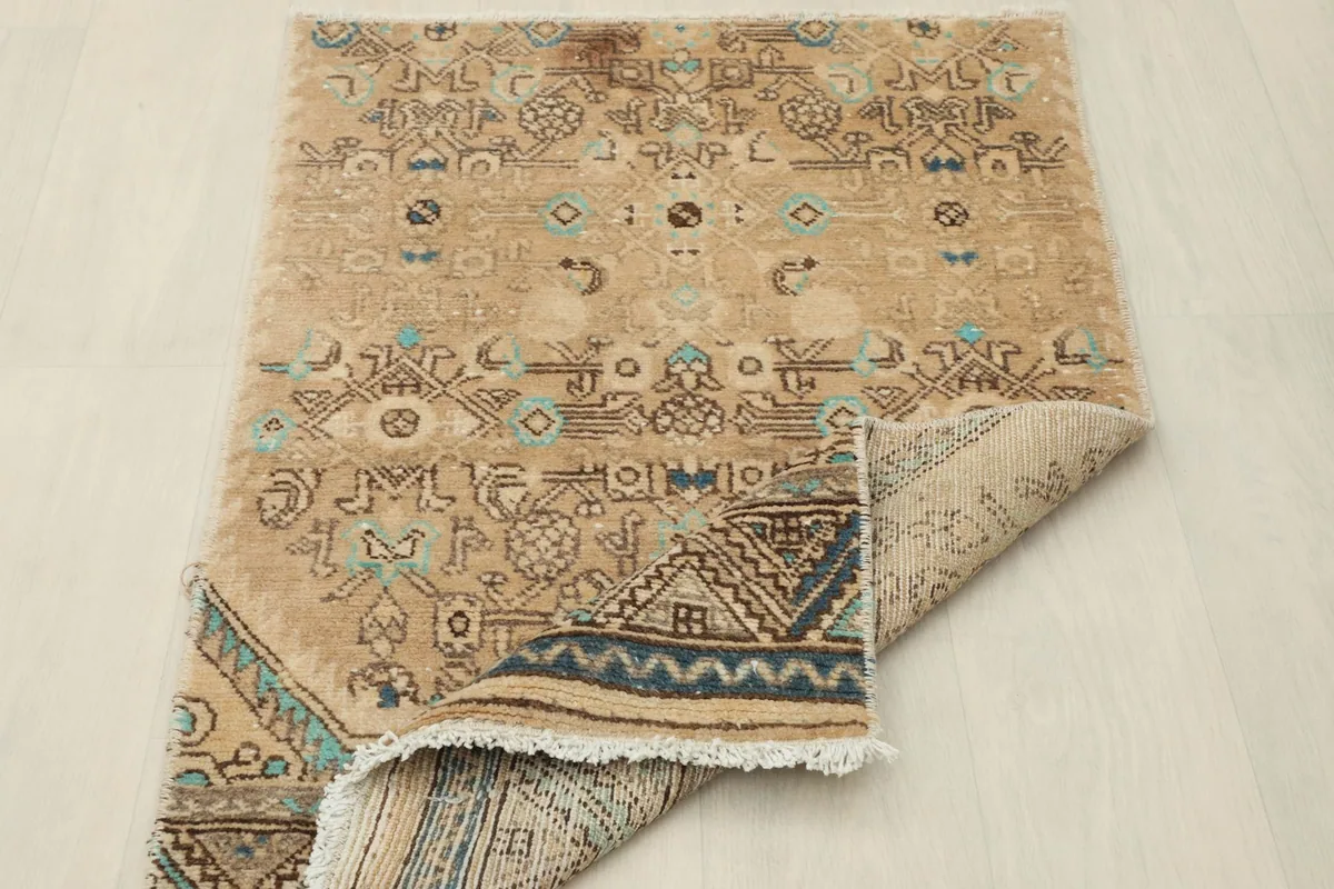 View of the rug's underside, revealing its hand-knotted construction