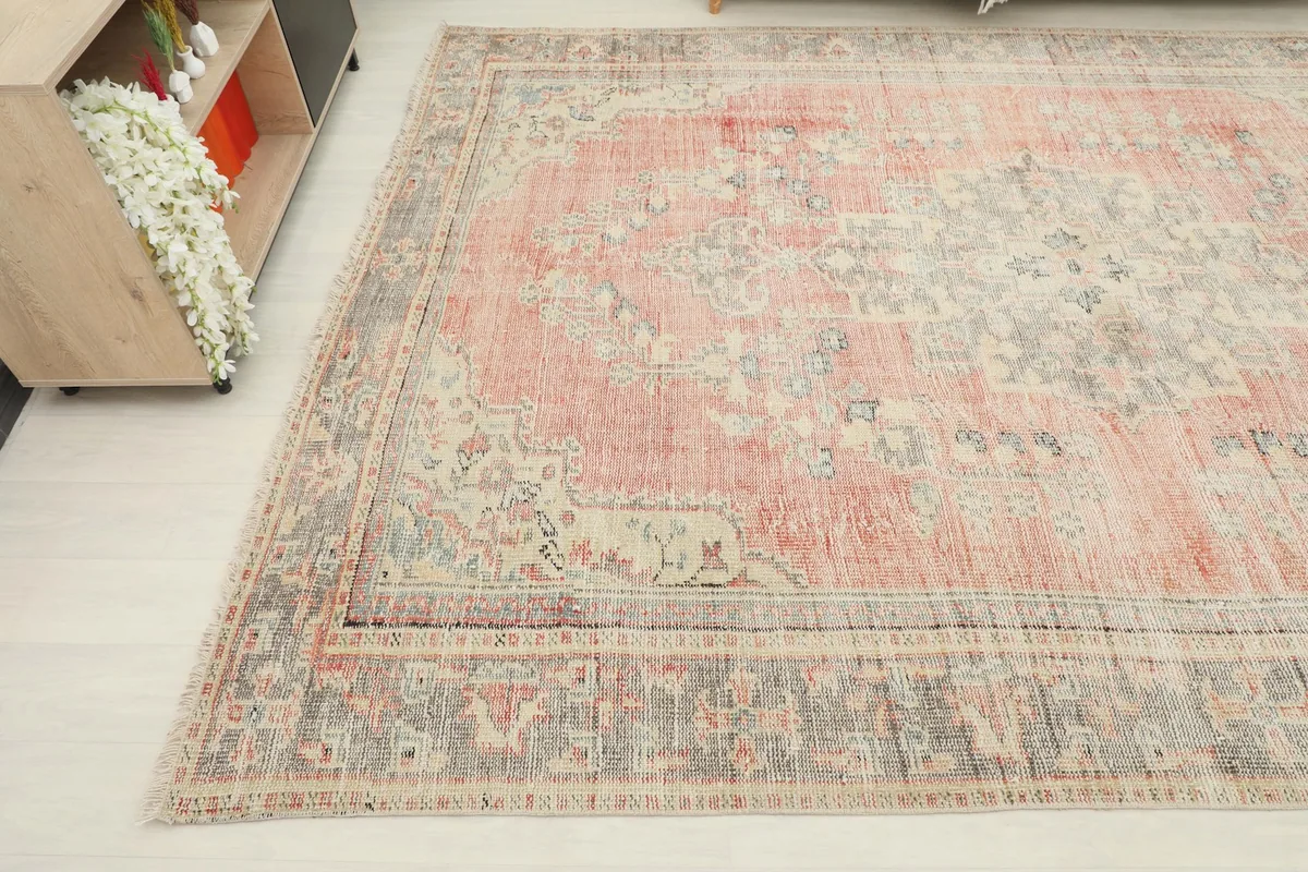 Another angle shot highlighting the faded rose colors and geometric patterns in the rug's design