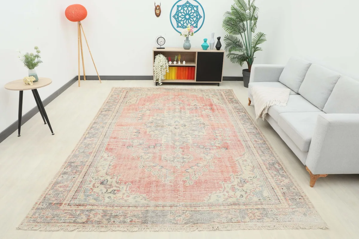 Overhead view of the vintage rose and gray rug in a staged room, showcasing its full design