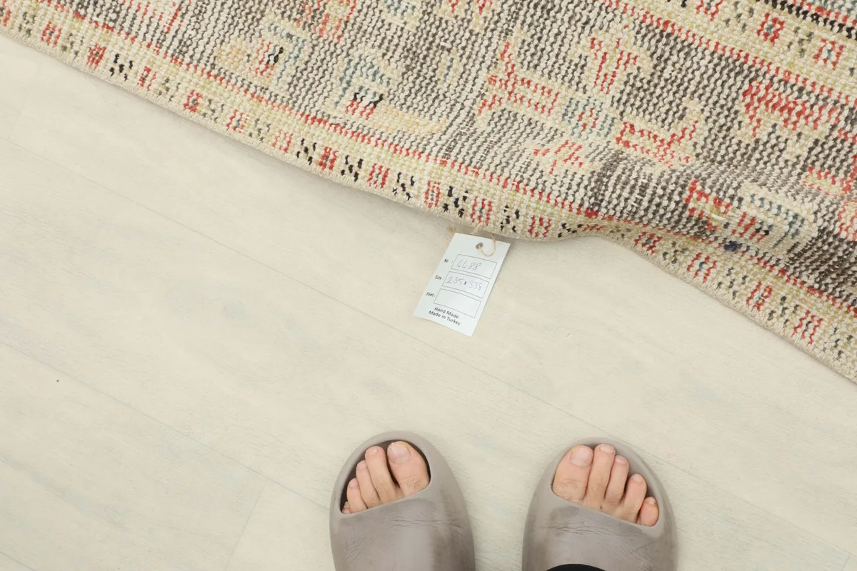 View of the rug's back, revealing the tight knotting and a product tag near the bottom edge