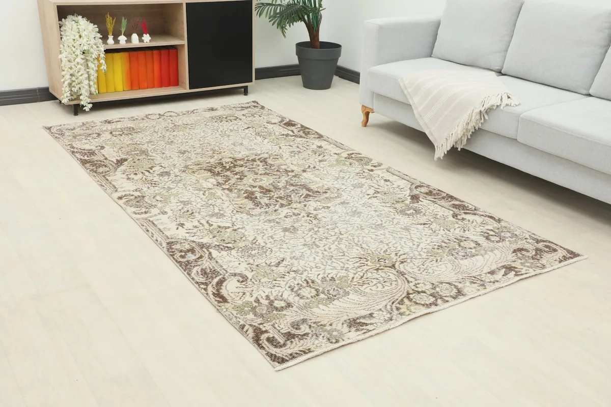 Angle view of the ivory floral rug in a modern living space with light wood floors