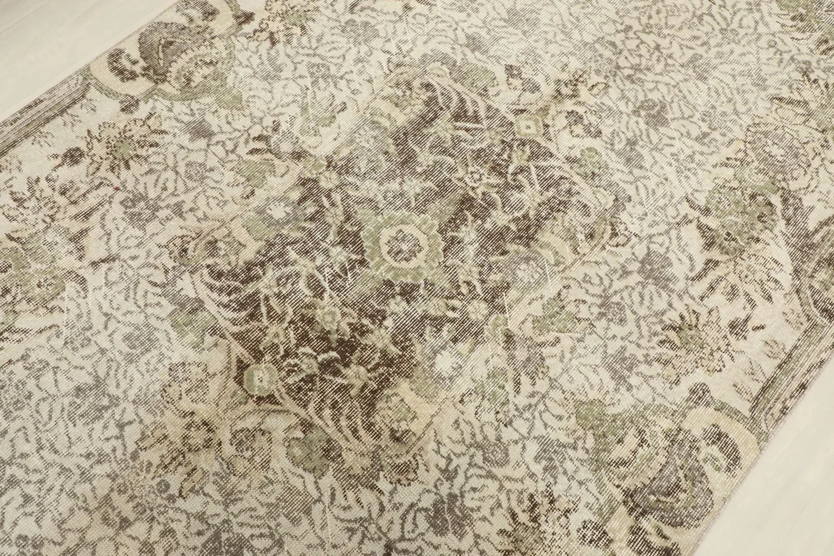 Close-up of the central medallion and surrounding floral motifs with natural wear