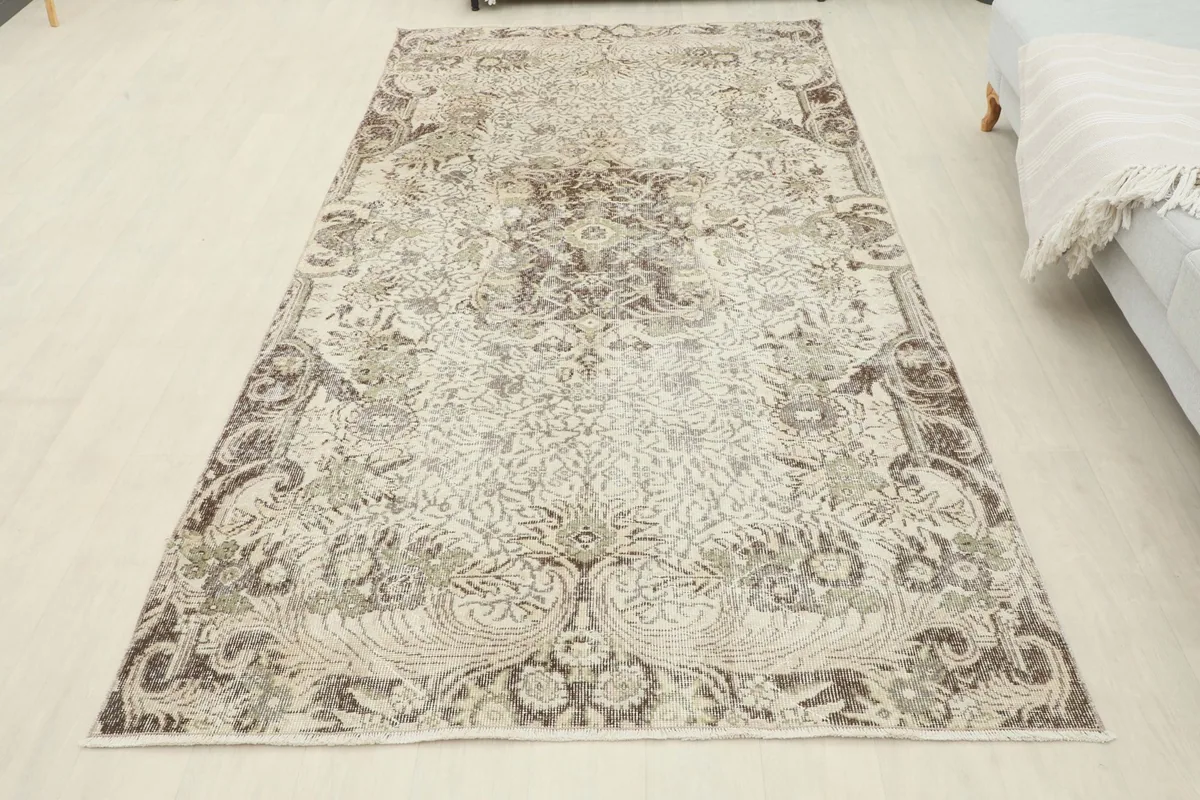 Full overhead view of the vintage Anatolian rug laid out in a room, showing its scale