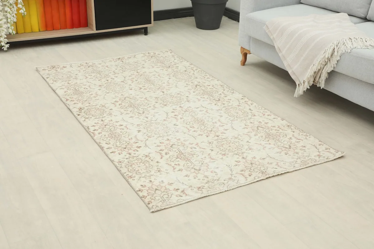 Angled view of the vintage Anatolian rug showcasing its floral pattern and colors