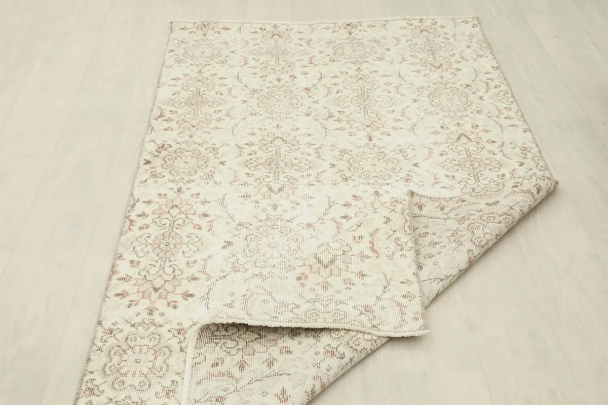 Partial fold of the rug displaying the density of the knots on the back