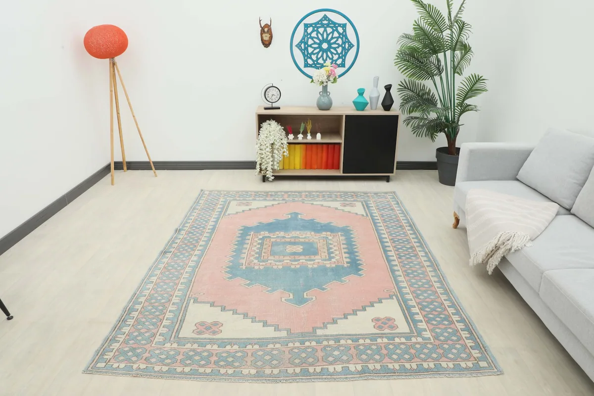 Full room shot of the pink and blue vintage Anatolian rug, demonstrating its impact on the decor