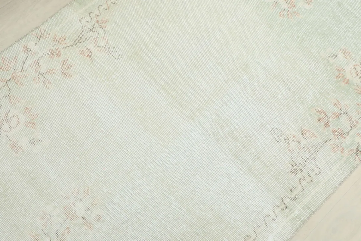 Diagonal view of the rug's surface, revealing the subtle color variations and hand-knotted texture