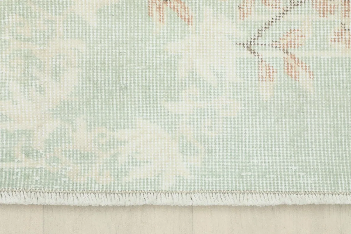 Close-up of the short fringe and the edge of the hand-knotted area rug