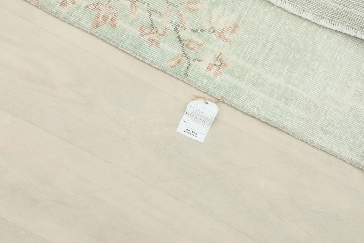 Small tag on the floor next to the rug, indicating professional cleaning