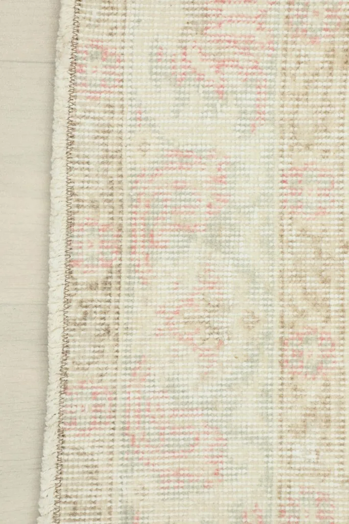 Underside view of the rug, showing the cotton foundation and hand-knotted construction