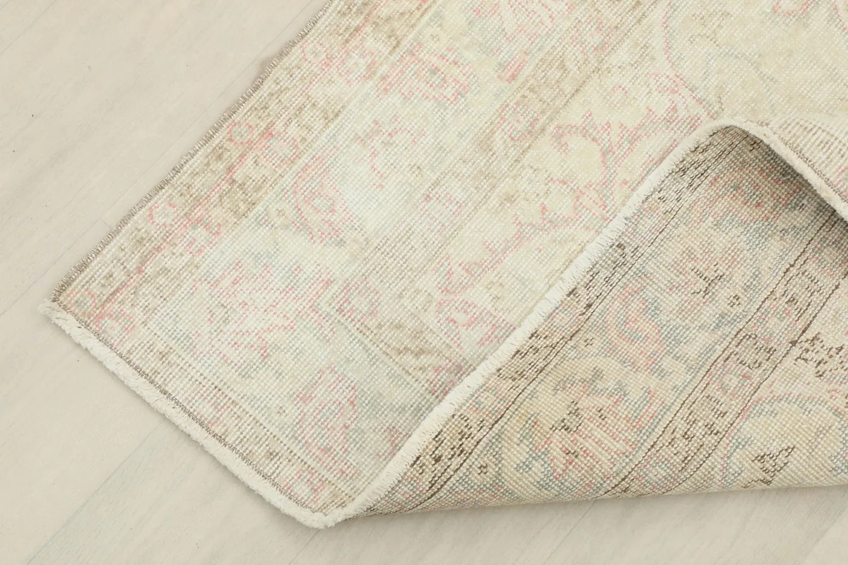Folded corner detail showing the reverse side of the rug's border and fringe