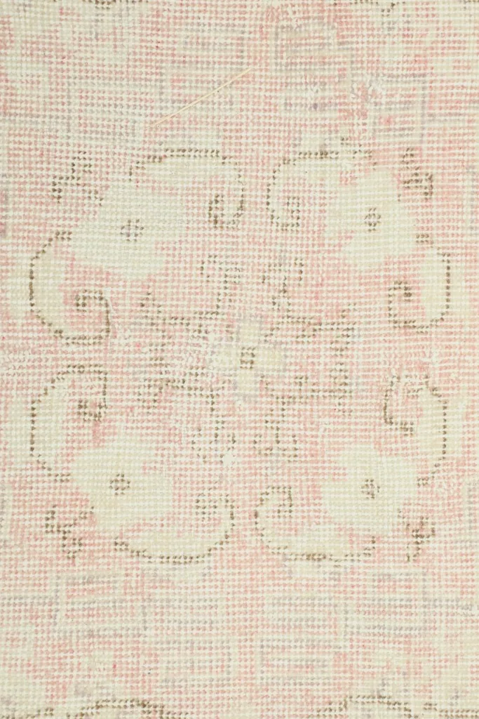 Close-up of the low wool pile, revealing the hand-knotted texture and color variations
