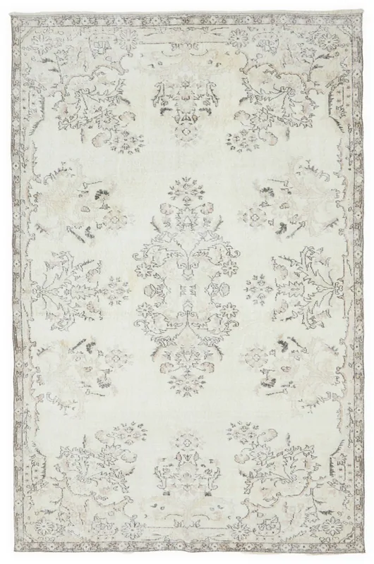 Full overhead view of the vintage ivory Anatolian rug with floral and geometric patterns.