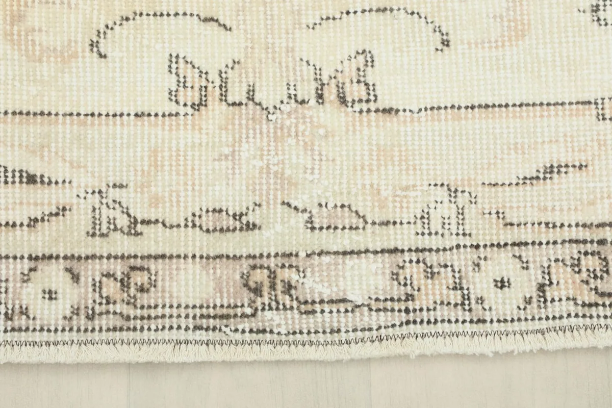 Detail of the rug's border, showcasing its intricate design and the low pile texture.