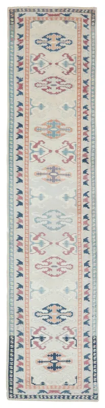 Full overhead view of the 2'9" x 12'0" cream vintage Anatolian runner rug with geometric tribal motifs.