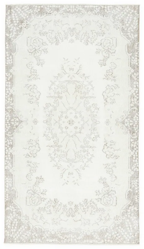 Full top view of the 3'8" x 6'7" ivory and tan vintage Anatolian area rug.
