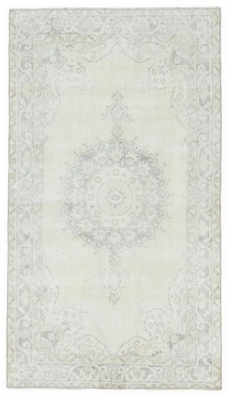 Full overhead view of the ivory and gray vintage Anatolian rug with a central medallion.